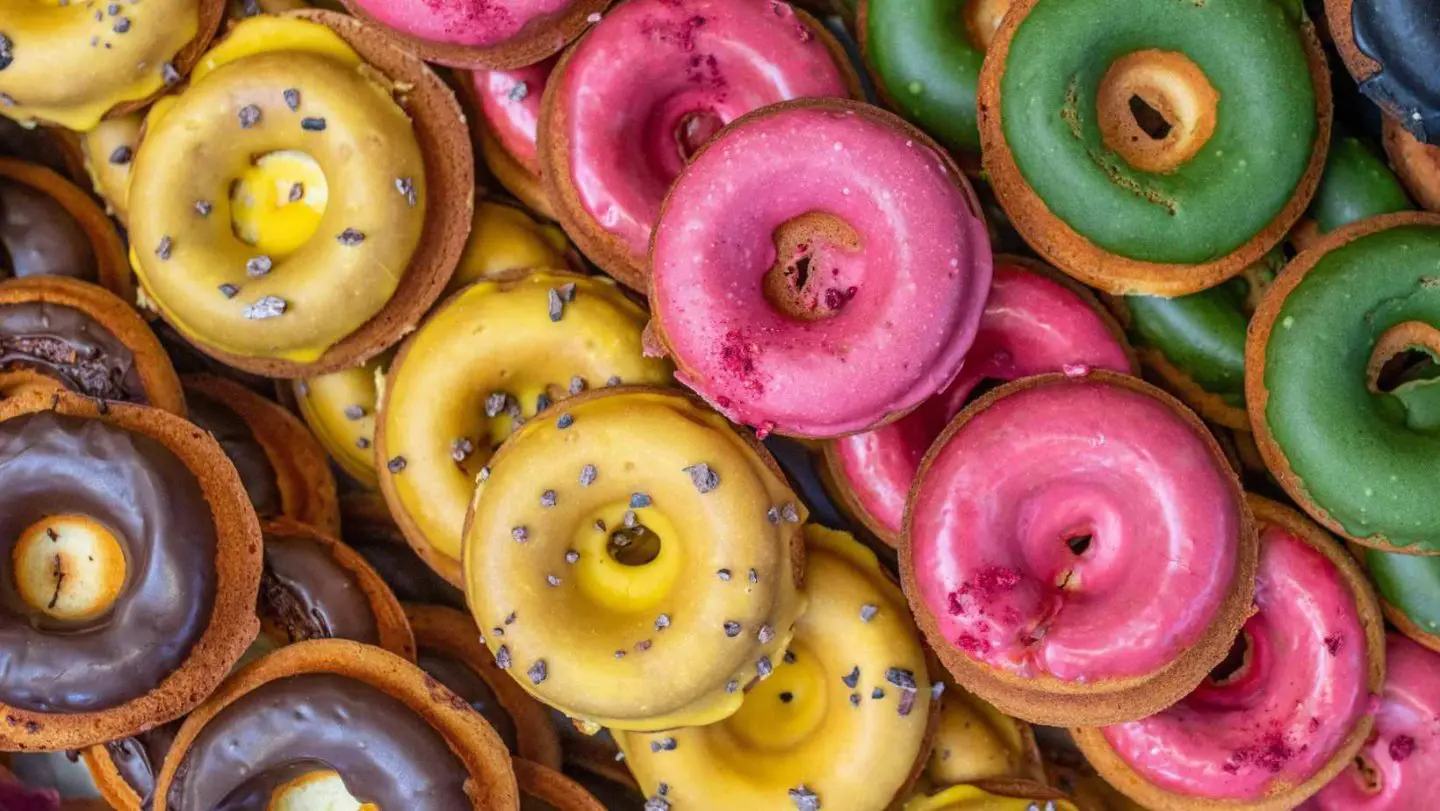 about us main photo - multiple lines of colorful donuts