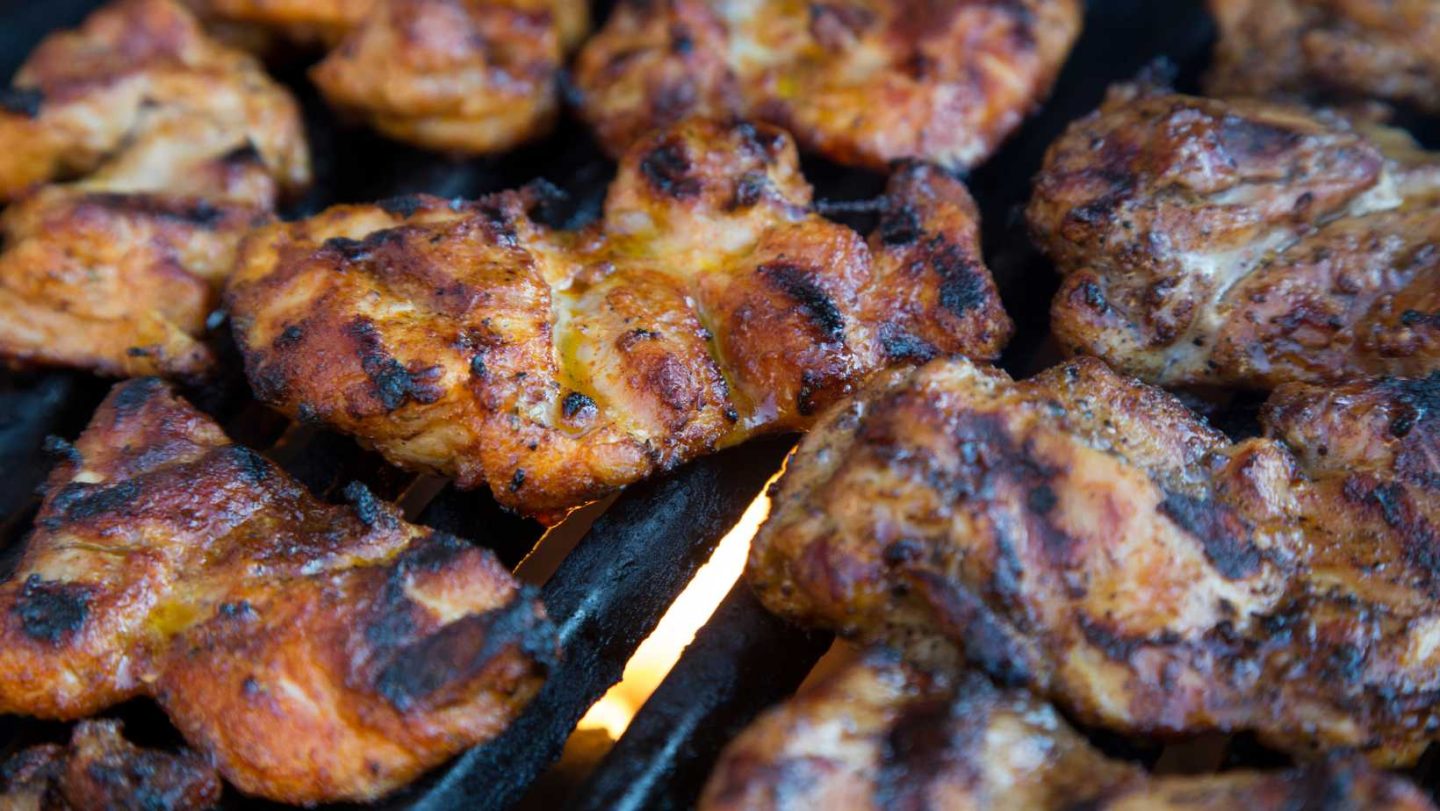 pork chop vs chicken breast - chicken thighs on a grill